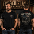 Two men wearing black t-shirts with 'Forged Flag Society' design, one facing forward and one facing away, in front of a rustic background with American flag.